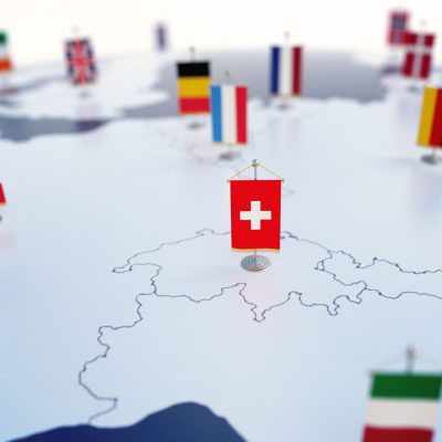 Flag of Switzerland in focus among other European countries flags. Europe marked with table flags 3d rendering